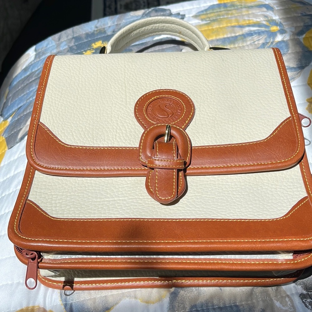 Super nice HANDBAG!  Unzips to reveal a card/ papers/ money compartment.